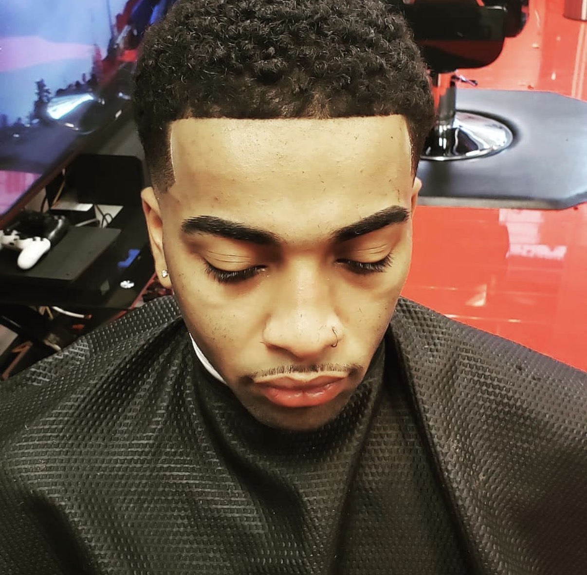 Curly textured haircut with a crisp front lineup